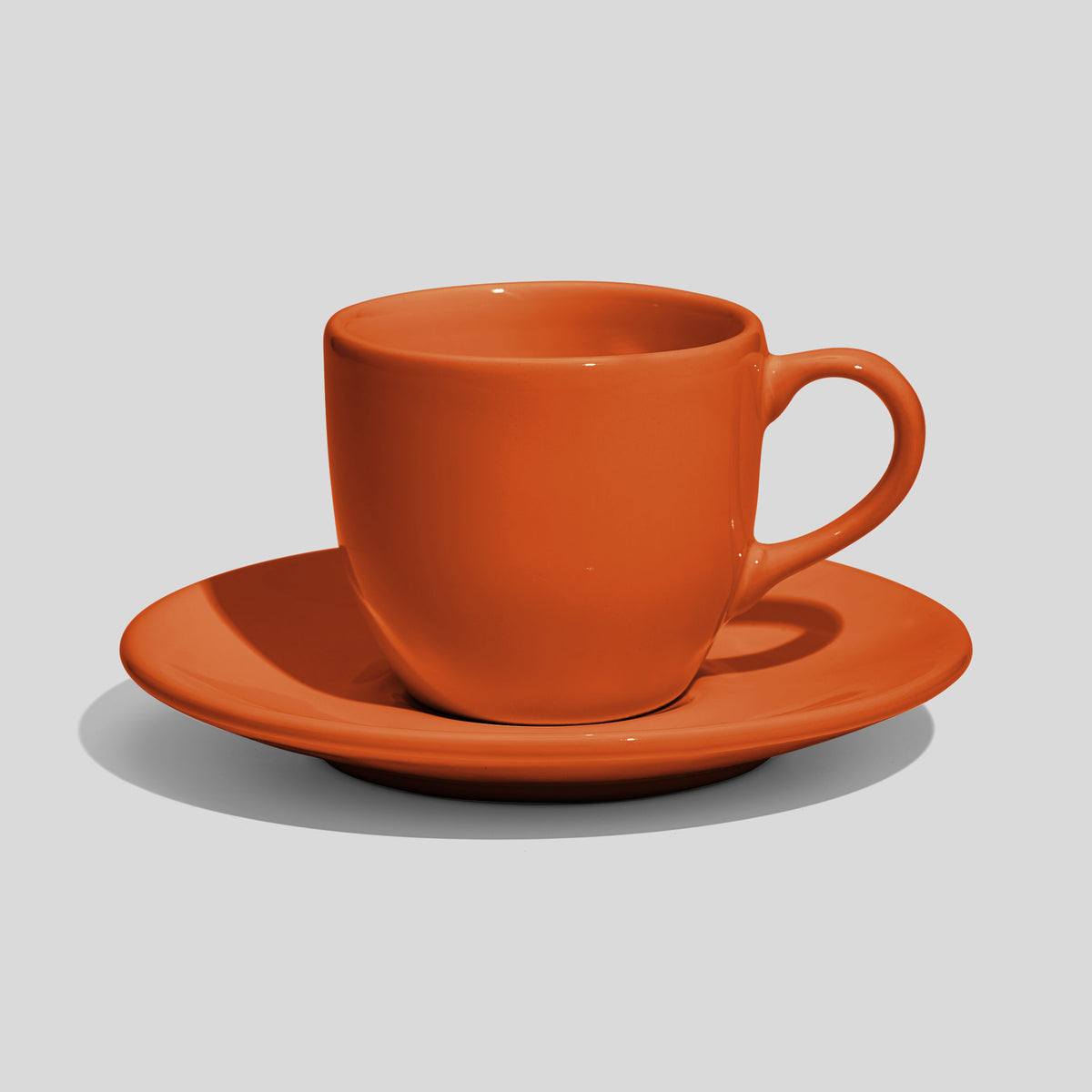Rundliche Tasse mit Untertasse 180 ml und Bogenhenkel – Orange