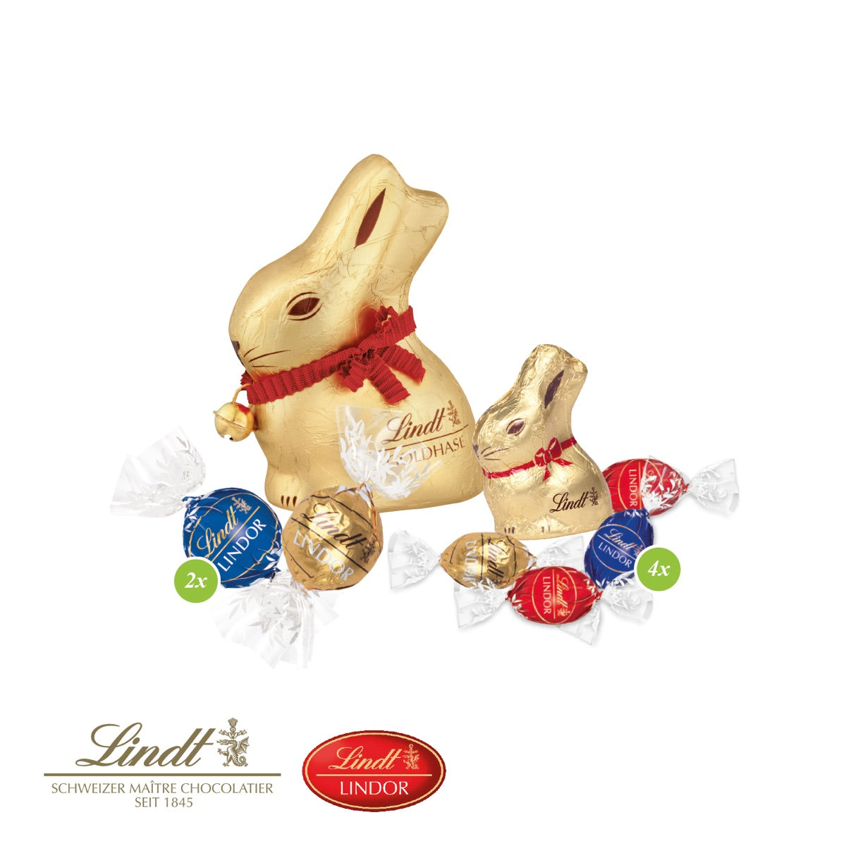 Zwei Goldhasen, Lindor Kugeln und Schokoladeneier von Lindt im Nest