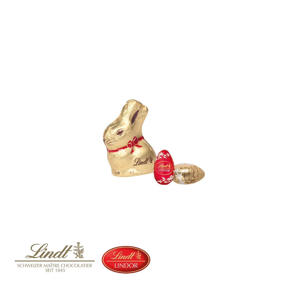 Lindt Goldhase und zwei Schokoladeneier in der offenen Präsentbox