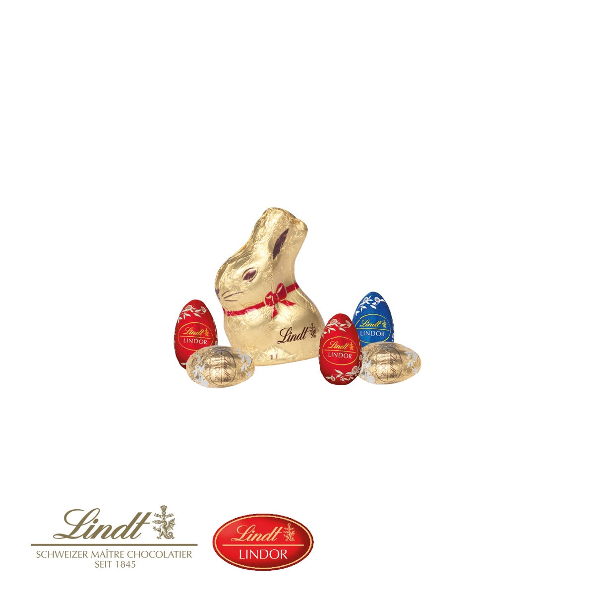 Goldhase und fünf Schokoladeneier von Lindt im Ostergras